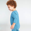 Load image into Gallery viewer, Baby boy wearing a blue one piece with leaf print