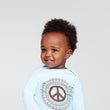 Load image into Gallery viewer, Happy baby wearing long sleeve onesie with peace sign print