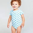 Load image into Gallery viewer, Happy baby wearing short sleeve onesie with lotus flower print