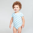 Load image into Gallery viewer, Happy baby wearing blue short sleeve onesie with lotus flower print