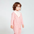 Load image into Gallery viewer, Baby girl wearing a pink long sleeve one piece with leaf print