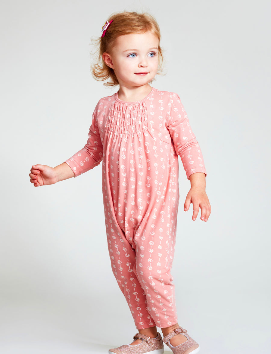 Baby girl wearing pink long sleeve one piece romper with small heart print