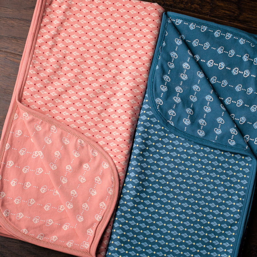 Baby blankets in pink and blue with heart and leaf print by Zia NYC